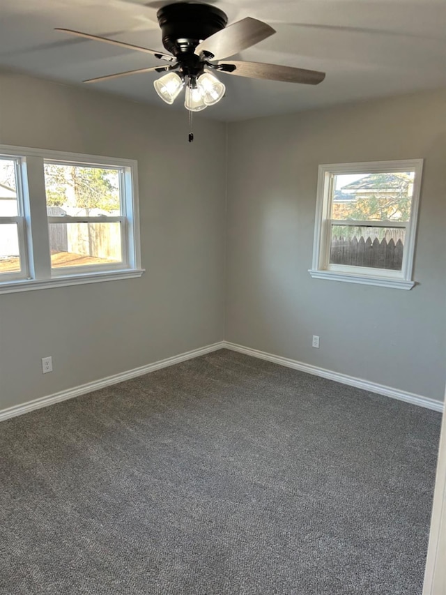 empty room featuring ceiling fan and carpet