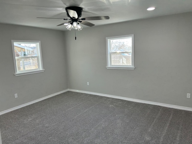 unfurnished room with carpet, a healthy amount of sunlight, and ceiling fan