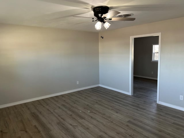 spare room with dark hardwood / wood-style floors and ceiling fan