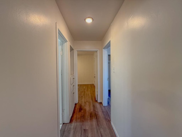 hallway with light hardwood / wood-style floors