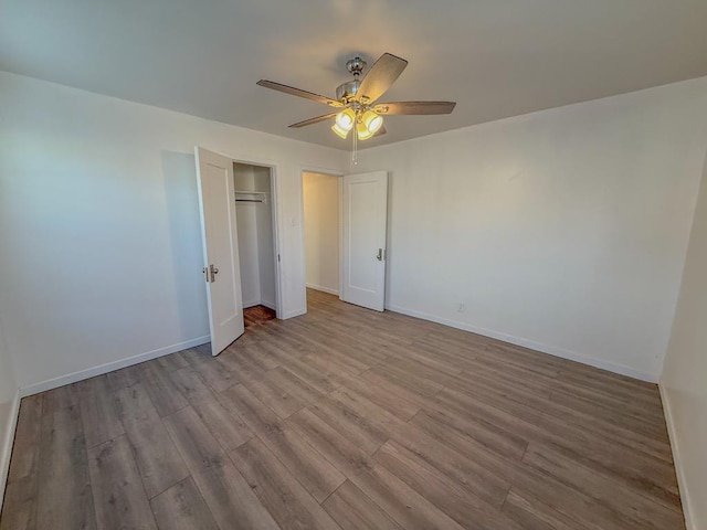 unfurnished bedroom featuring light hardwood / wood-style floors, a closet, and ceiling fan