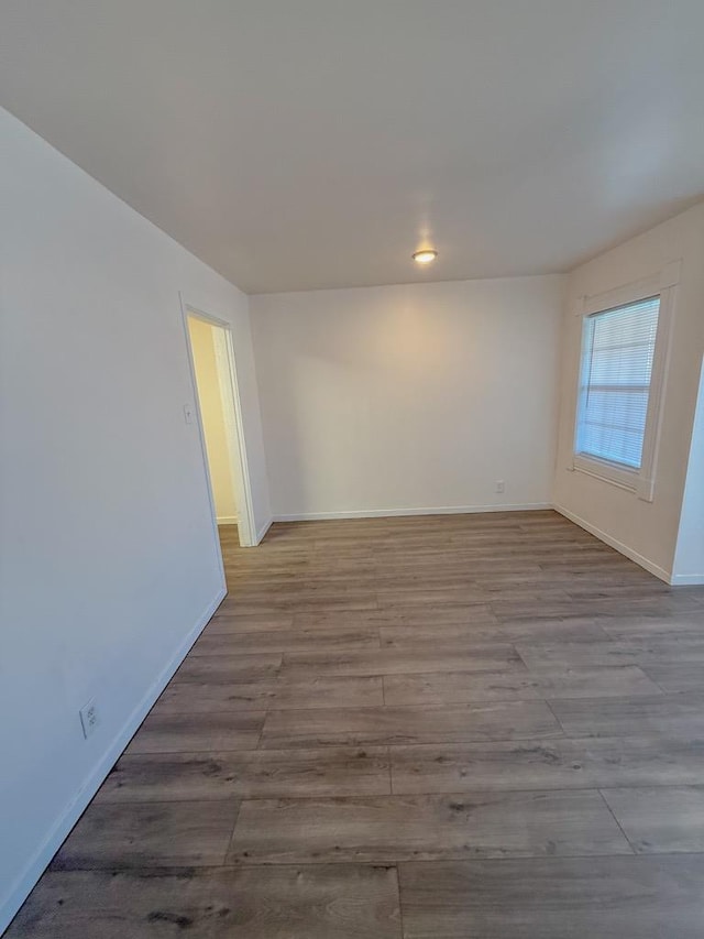 empty room with light hardwood / wood-style flooring