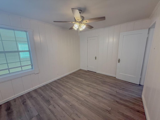 unfurnished bedroom with hardwood / wood-style floors and ceiling fan