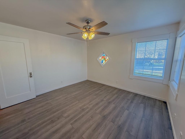 empty room with hardwood / wood-style flooring and ceiling fan