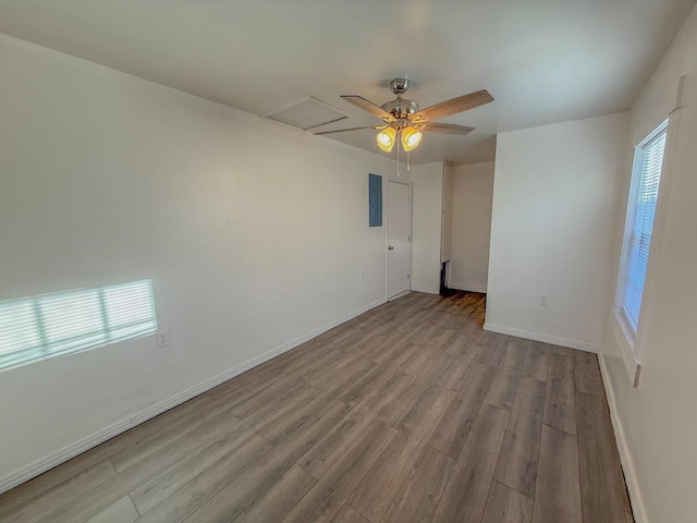 spare room with ceiling fan and light wood-type flooring