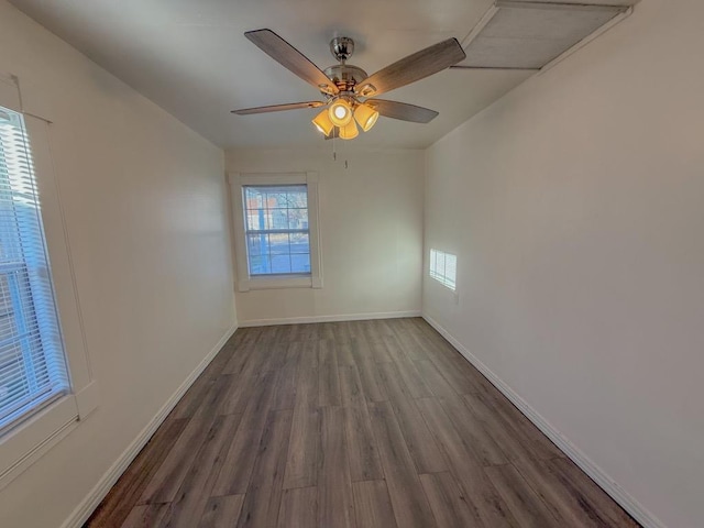 unfurnished room with dark wood-type flooring and ceiling fan