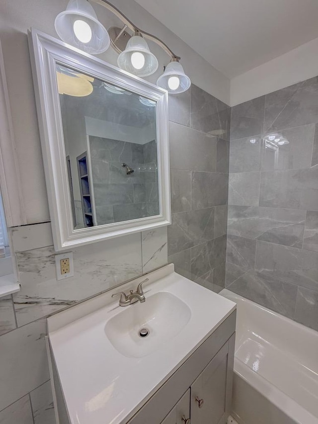 bathroom featuring vanity, tile walls, and backsplash