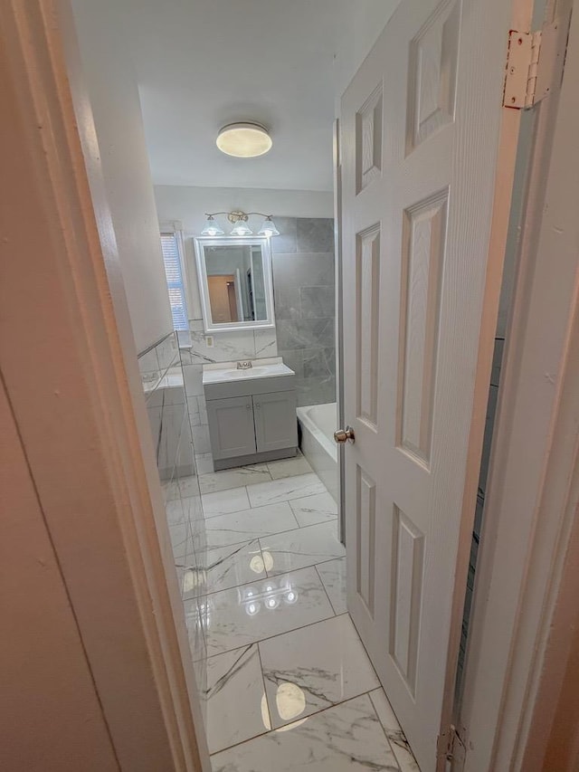 bathroom featuring vanity and a tub