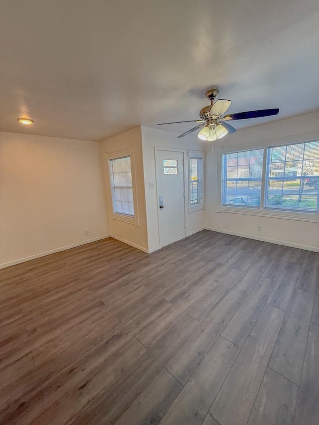 interior space featuring wood-type flooring and ceiling fan