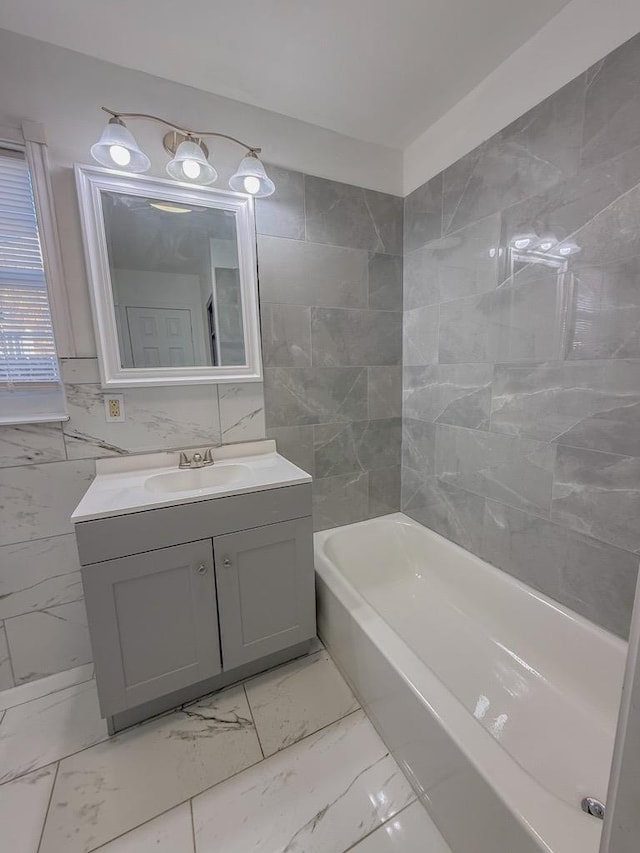 bathroom featuring vanity and tile walls