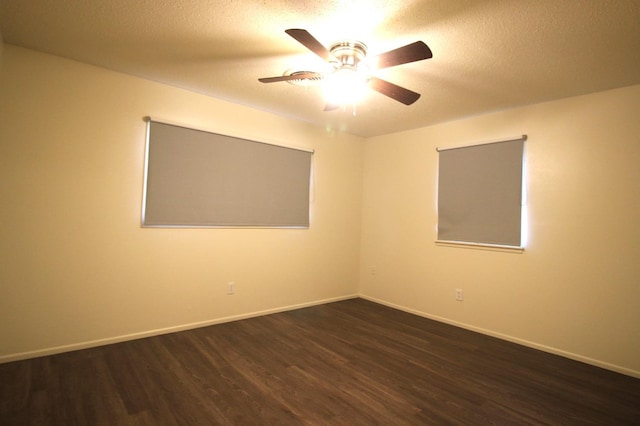 spare room with ceiling fan, dark wood-type flooring, and a textured ceiling