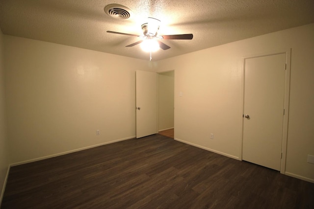 unfurnished bedroom with ceiling fan, dark hardwood / wood-style flooring, and a textured ceiling