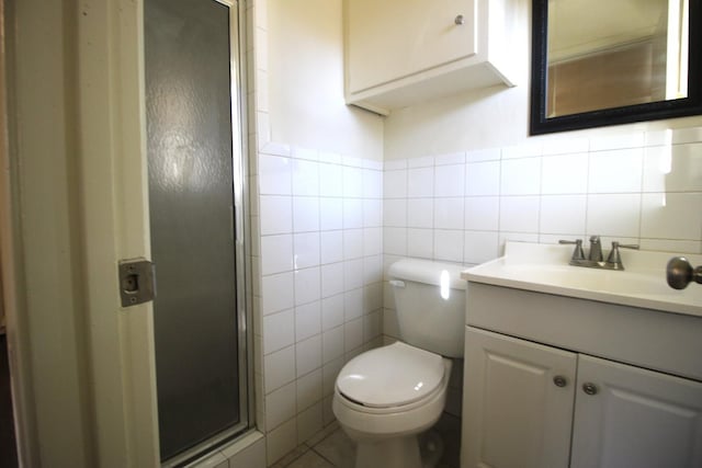 bathroom featuring vanity, tile walls, toilet, and walk in shower