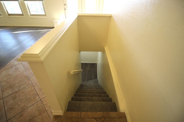 stairs with tile patterned flooring