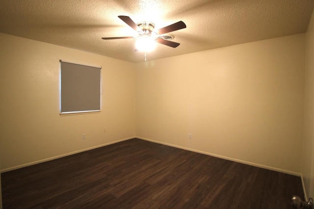 unfurnished room featuring dark hardwood / wood-style flooring, a textured ceiling, and ceiling fan