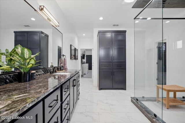9105 Kewanee Ave, Lubbock, TX 79424 - full bath with marble look tiles, vanity, recessed lighting, and a stall shower
