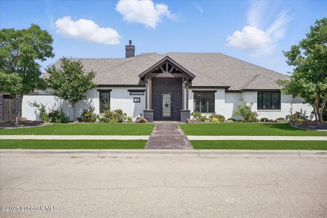 9105 Kewanee Ave, Lubbock, TX 79424 - view of front of home featuring a chimney and a front lawn