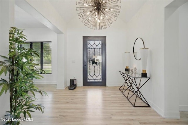 9105 Kewanee Ave, Lubbock, TX 79424 - foyer entrance featuring wood finished floors, plenty of natural light, baseboards, a chandelier, and high vaulted ceiling