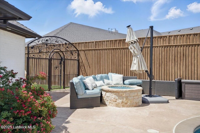 9105 Kewanee Ave, Lubbock, TX 79424 - view of patio / terrace featuring a gate and an outdoor living space with a fire pit