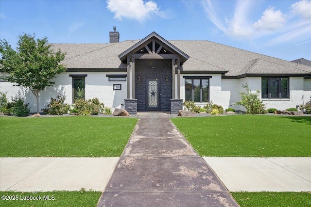 9105 Kewanee Ave, Lubbock, TX 79424 - view of front facade featuring a chimney, a front yard, a shingled roof, and brick siding