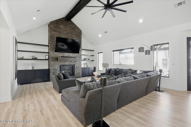 9105 Kewanee Ave, Lubbock, TX 79424 - living area featuring a ceiling fan, beam ceiling, light wood-type flooring, a fireplace, and high vaulted ceiling