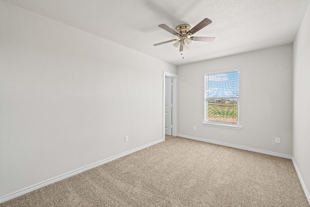 carpeted empty room with a textured ceiling and ceiling fan