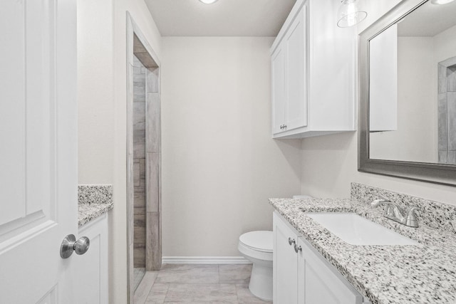 bathroom with vanity, toilet, and walk in shower