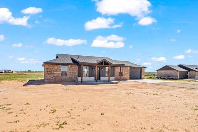 view of front of house featuring a garage and a porch