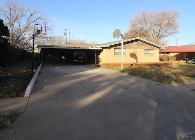 view of side of home with a carport and a lawn