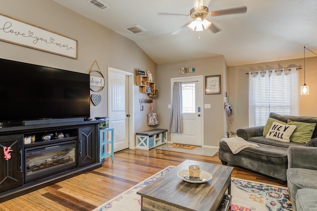 living room featuring vaulted ceiling, wood-type flooring, and ceiling fan