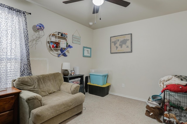 sitting room with light colored carpet and ceiling fan