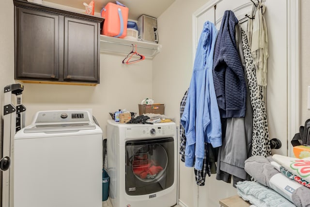 laundry area with cabinets and washing machine and clothes dryer