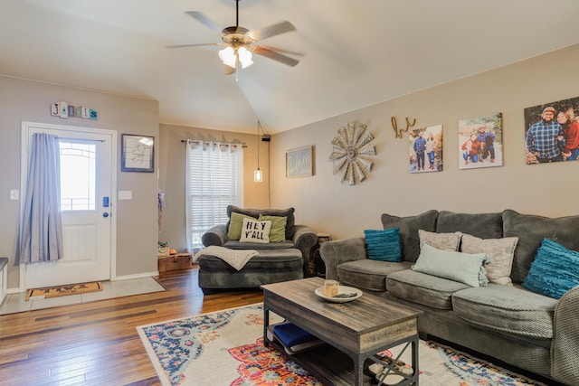 living room with hardwood / wood-style floors, vaulted ceiling, and ceiling fan