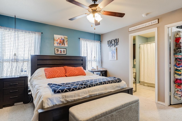 carpeted bedroom featuring connected bathroom and ceiling fan