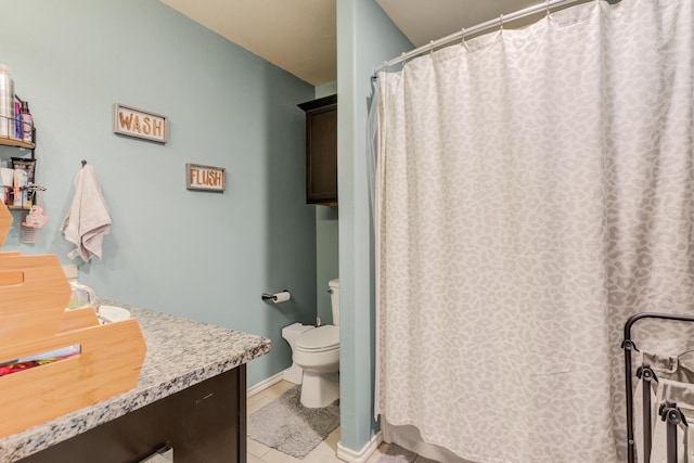 bathroom featuring vanity, tile patterned floors, and toilet