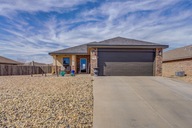 view of front of home featuring a garage and central AC