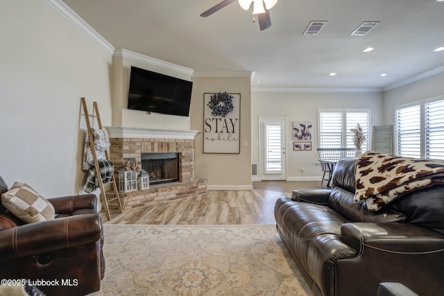 7204 90th St, Lubbock, TX 79424 - living room with a ceiling fan, crown molding, wood finished floors, baseboards, and a fireplace