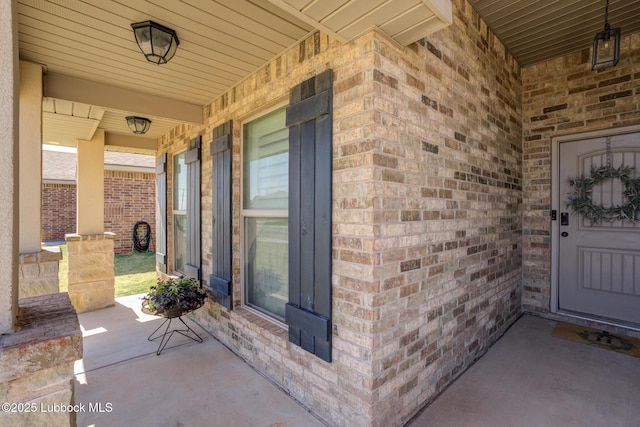 7204 90th St, Lubbock, TX 79424 - view of exterior entry with covered porch and brick siding