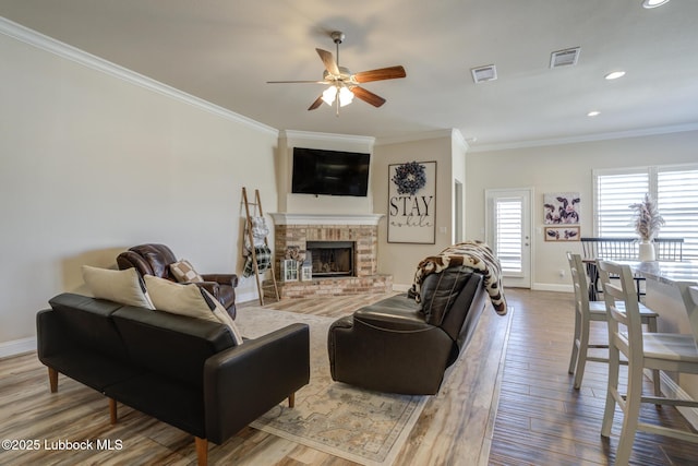 7204 90th St, Lubbock, TX 79424 - living area with a ceiling fan, crown molding, baseboards, wood finished floors, and a fireplace