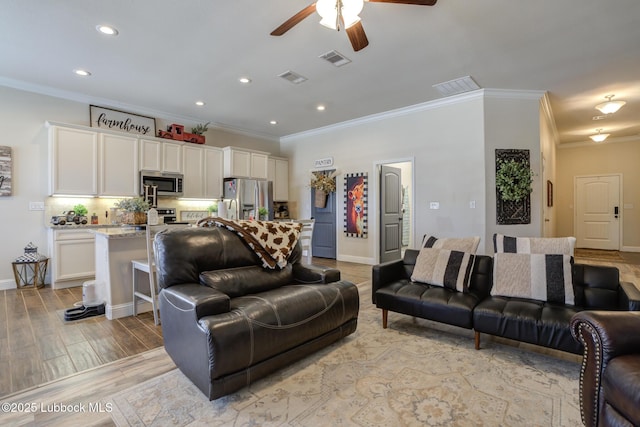 7204 90th St, Lubbock, TX 79424 - living area with crown molding, recessed lighting, ceiling fan, light wood-style floors, and baseboards