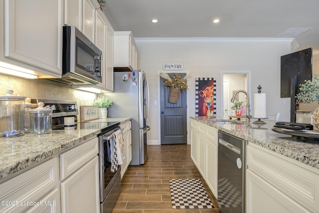 7204 90th St, Lubbock, TX 79424 - kitchen featuring appliances with stainless steel finishes, a sink, crown molding, backsplash, and white cabinets