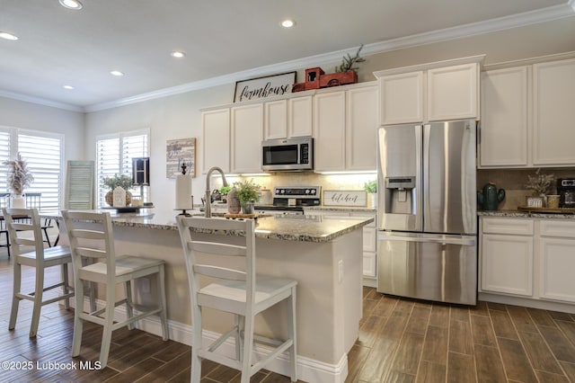 7204 90th St, Lubbock, TX 79424 - kitchen featuring appliances with stainless steel finishes, light stone countertops, dark wood-type flooring, ornamental molding, and decorative backsplash