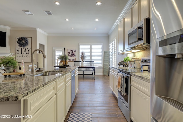 7204 90th St, Lubbock, TX 79424 - kitchen with stainless steel appliances, a sink, recessed lighting, light stone countertops, and crown molding