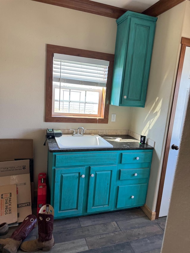 interior space featuring hardwood / wood-style flooring, ornamental molding, and vanity