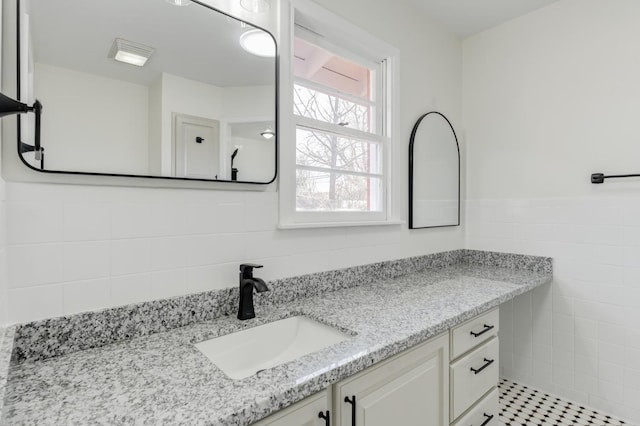 bathroom featuring vanity and tile walls