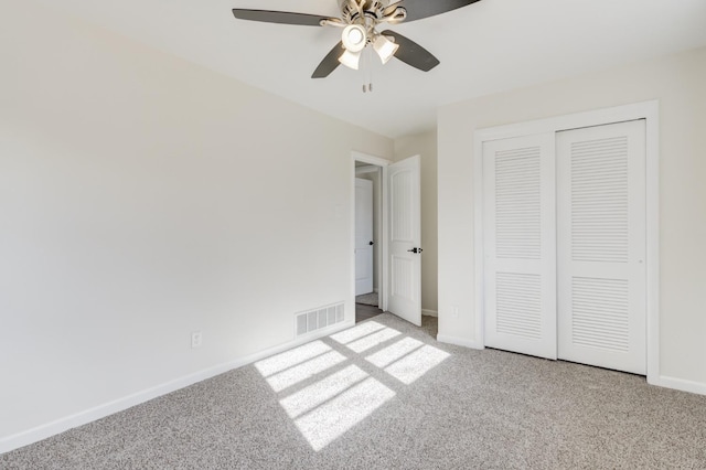 unfurnished bedroom with light carpet, ceiling fan, and a closet