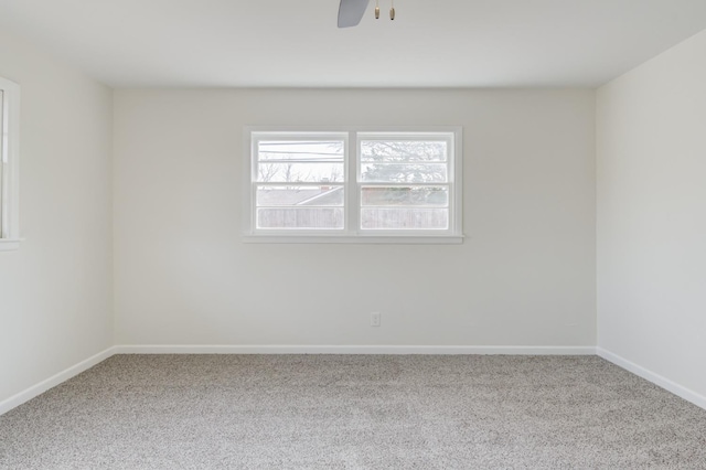 spare room featuring ceiling fan and carpet flooring