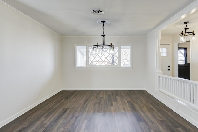 unfurnished dining area featuring dark hardwood / wood-style flooring, ornamental molding, and a chandelier