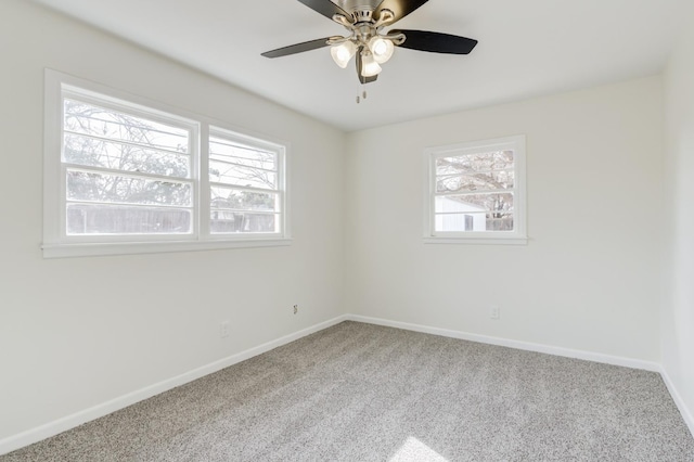 spare room featuring ceiling fan, plenty of natural light, and carpet floors