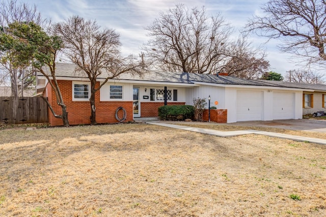 single story home with a garage and a front lawn